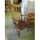 An early 20th century lathe back elbow chair