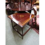 An Edwardian mahogany inlaid square topped table with turned and galleried under