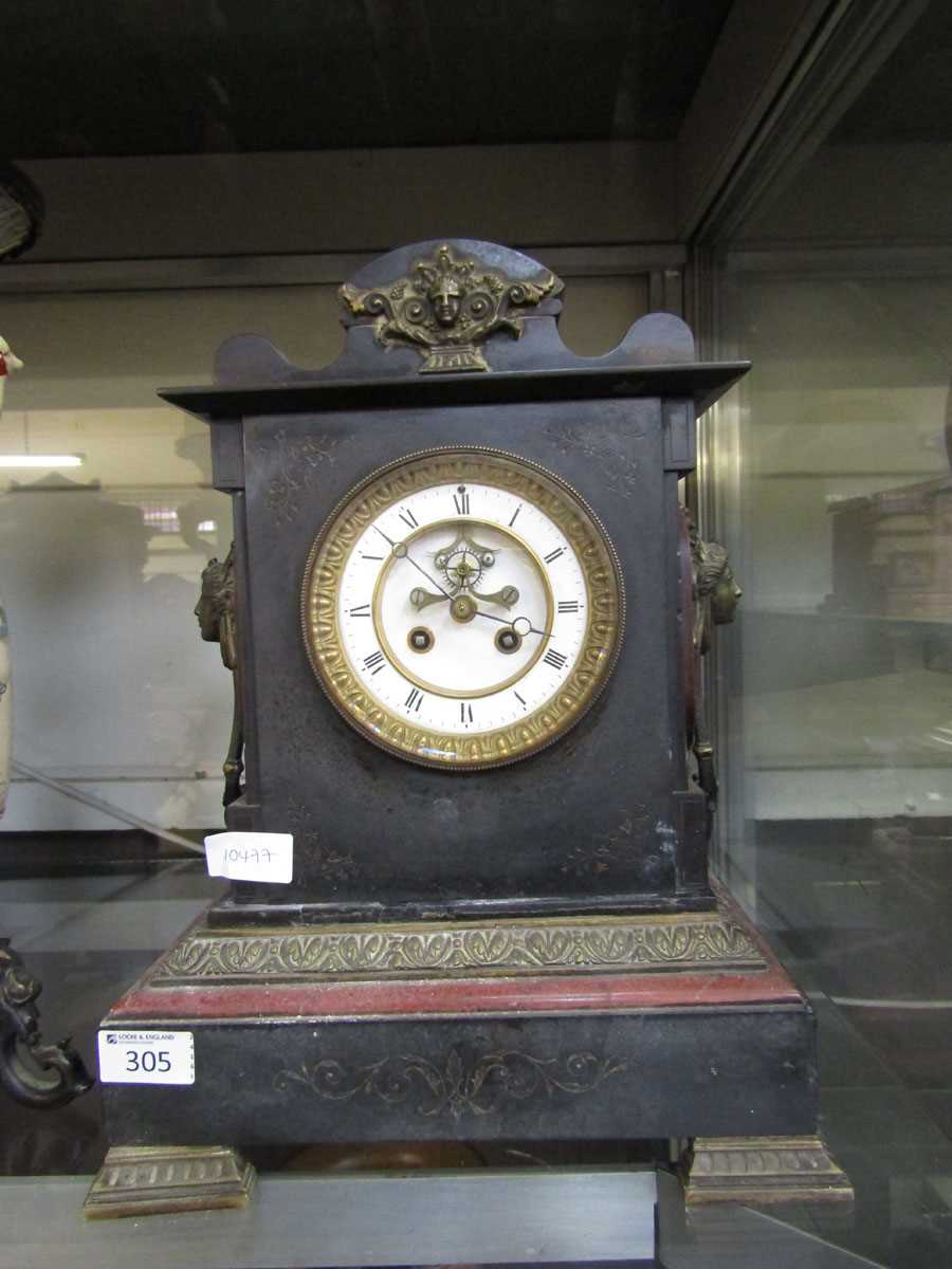 A Victorian black slate and brass mounted mantel clock on brass bracket feet