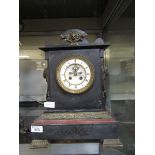 A Victorian black slate and brass mounted mantel clock on brass bracket feet