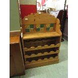 A waxed pine wine rack with tiled back