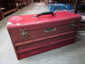 A red metal toolbox containing a quantity of spanners, grips, etc