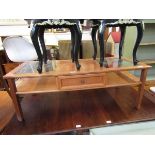 A mid-20th century design teak coffee table having two glazed sections to top with single drawer