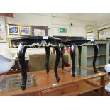 A pair of black and gilt decorated circular topped occasional tables