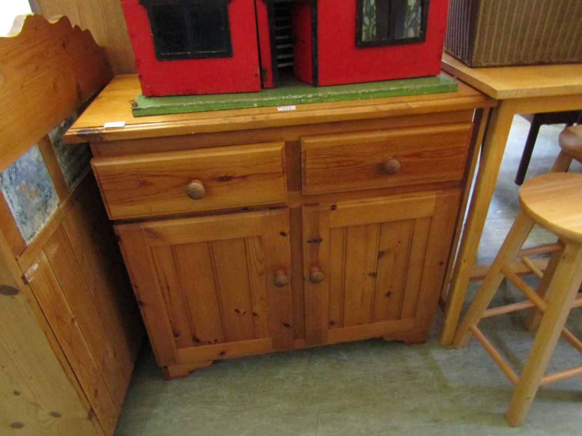 A small pine dresser base having two drawers above two cupboard doors