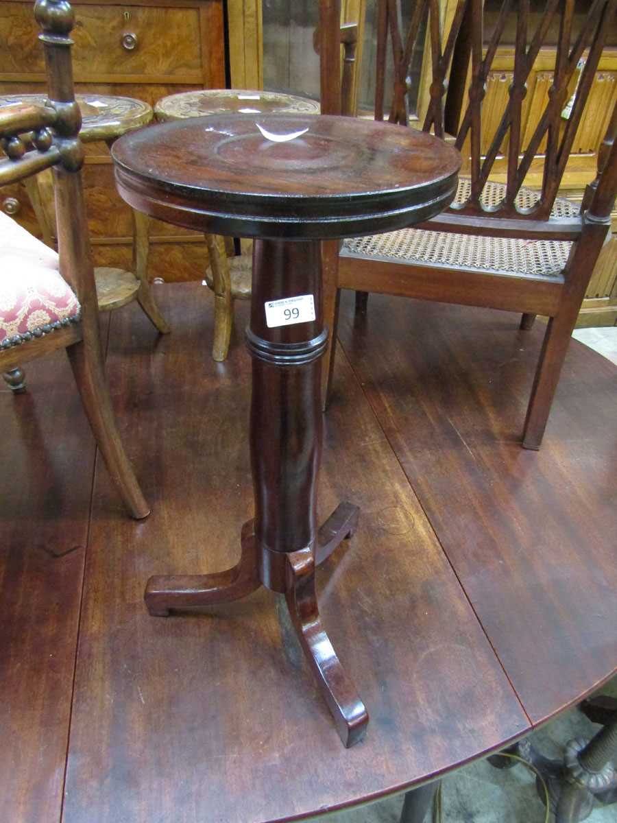 A circular topped wooden jardiniere stand