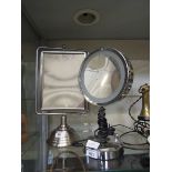 A stainless steel desktop swing mirror along with one other light-up desktop mirror