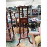 A reproduction mahogany jardiniere stand having two drawers (A/F)