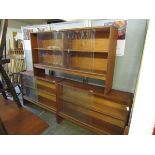 A pair of mid-20th century teak glazed sliding bookcases together with one similar
