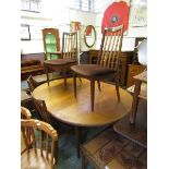 A mid-20th century teak extending dining table with a set of four matching chairs