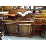 A Victorian mahogany chiffonier having raised back with fruit design, the base having two cushion