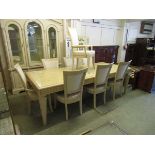 A continental limed oak effect extending dining table with two centre leaves together with a set