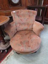A Victorian mahogany framed tub chair upholstered in a floral button back fabric