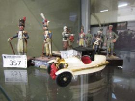 An assortment of eleven hand painted lead figurines of military gentlemen along with a die cast