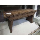 An early 20th century wooden footstool