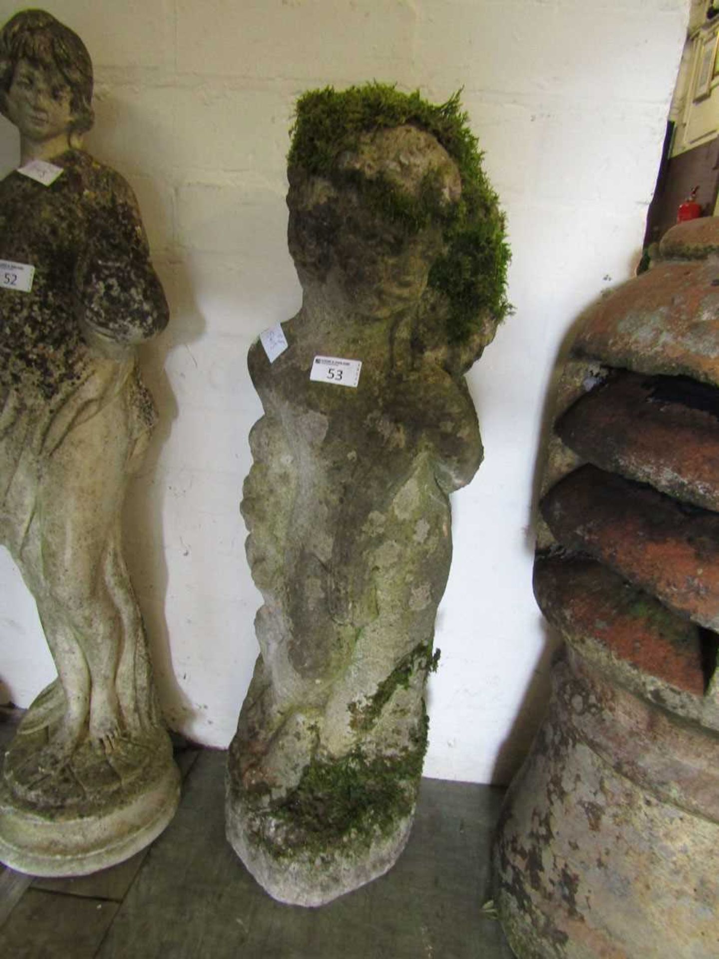 A weathered stoneware model of cherub