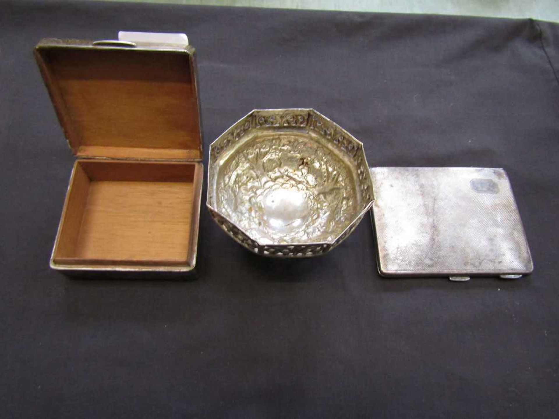 A silver hallmarked cigarette box with a plated cigarette case and a white metal bowl