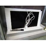 A Bang and Olufsen TV with remote