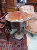 An early 20th century mahogany circular topped pedestal table