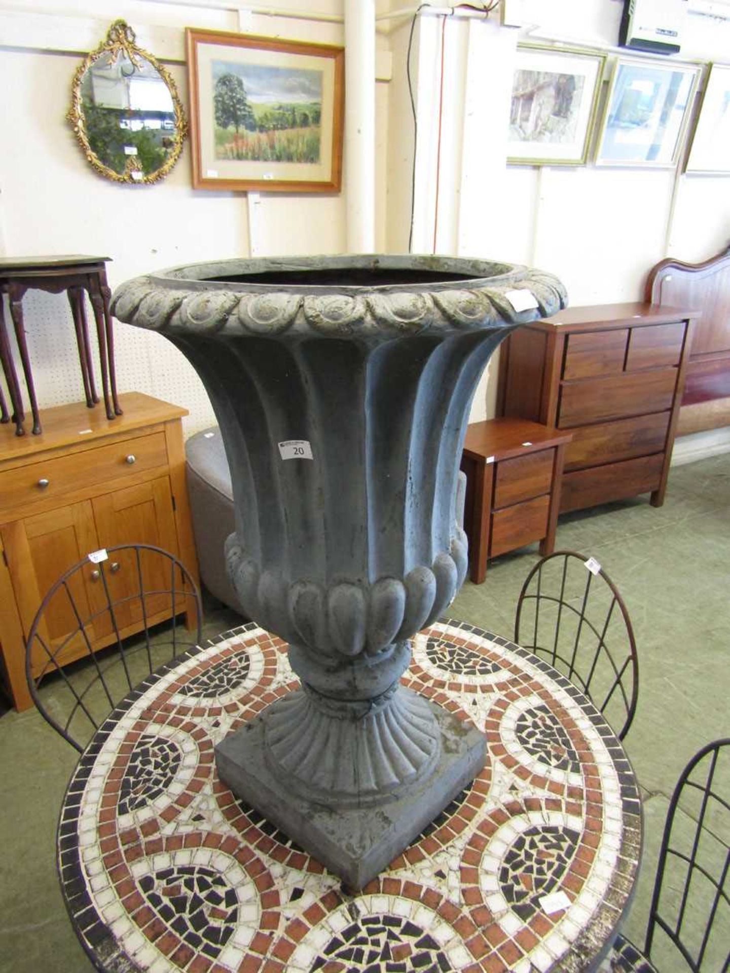 A grey painted PVC garden urn