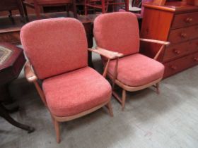 A pair of Ercol open armchairs with pink cut fabric cushions No model number apparent.