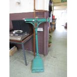 A set of green Avery scales together with a wooden measuring stick