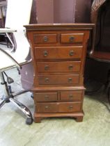 A miniature reproduction mahogany chest on chest