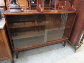 A mid-20th century oak bookcase with two sliding glazed doors