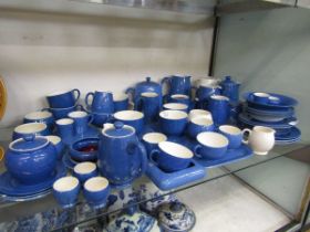 A large selection of blue Moorcroft ceramic tableware to include teapots, cream jugs, cups, saucers,