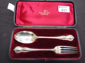 A cased silver hallmarked Walker and Hall spoon and fork set, approx. weight 74g