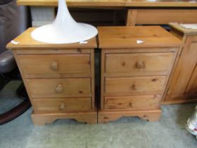 A pair of waxed pine three drawer bedside chests