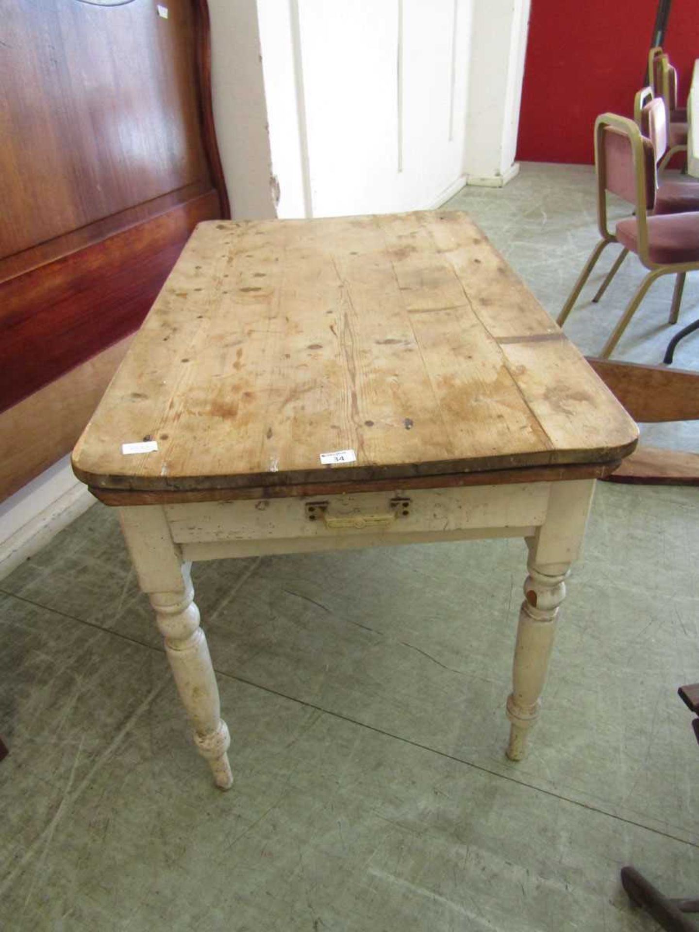 An old pine scrubbed top rectangular table with a painted base