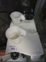 A pair of mid-20th century style white ceramic coffee sets by Villeroy and Boch consisting of two