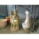 A weathered stoneware statue of a young girl together with a weathered stoneware statue of a goose