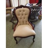 A reproduction spoon back nursing chair