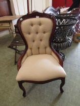 A reproduction spoon back nursing chair