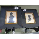 A pair of framed and glazed silhouettes of lady and gentleman with bronzing to frame