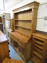 A waxed pine dresser having plate rack with six drawer to top, the base having three drawers above