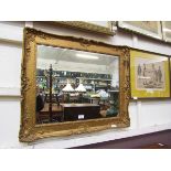 An over painted gilt framed wall mirror