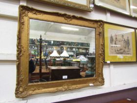 An over painted gilt framed wall mirror