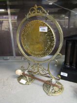 A reproduction oriental brass gong on stand