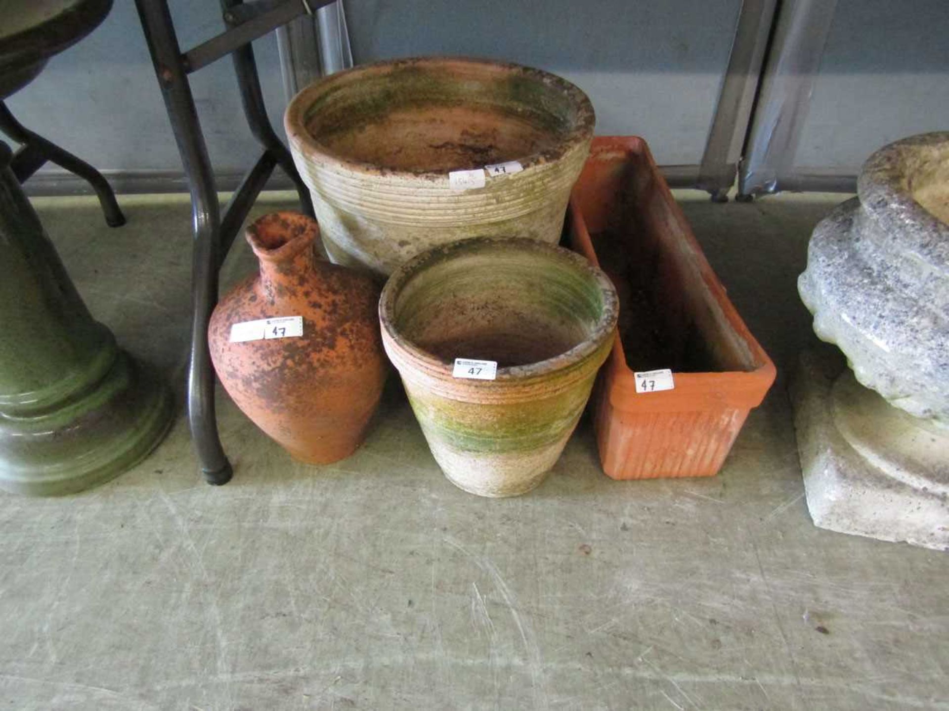 A selection of weathered garden clay pots and troughs
