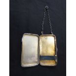 A silver hallmarked engraved cigarette case with with chain, approx. weight 49g