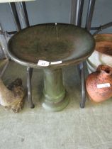 A green glazed birdbath