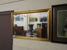 A modern gilt framed bevel glass wall mirror