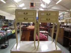 A pair of mid-20th century cream and gilt decorated Queen Anne style bedside chests of two drawers