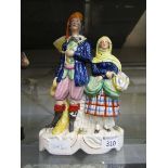 A Staffordshire ceramic figural group of lady and gent carrying fish