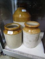 A large stoneware flagon along with two similar storage pots