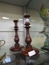 A near pair of early 20th century mahogany candlesticks