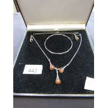 A silver hallmarked bangle together with a modern orange stoned necklace and matching earrings